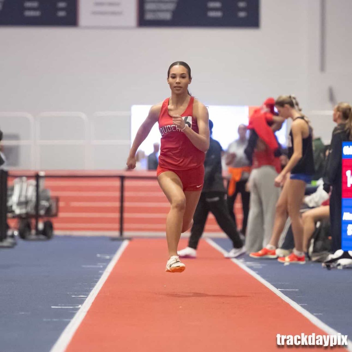 Going the distance…Sprinting into action, senior Laysha Lee participates in the triple jump event. The Meet of Champions took place on February 13. 

