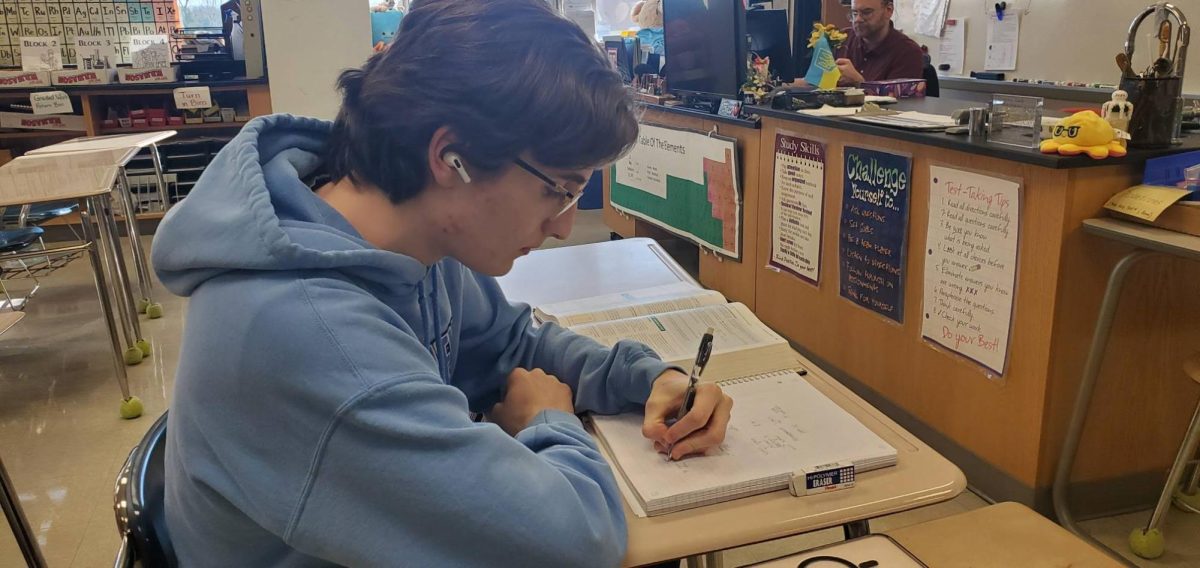 Feeling the beat…Listening to music, senior Nathan Stevens lets the music help to relax him while studying. Stevens listens to calm music to help relax.
