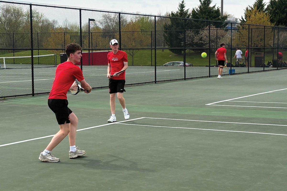 Backhand!...Attempting to win a point, freshman Joshua Kennedy participates in a doubles match against Cheltenham High School on April 14. Souderton lost to Cheltenham 6-1.