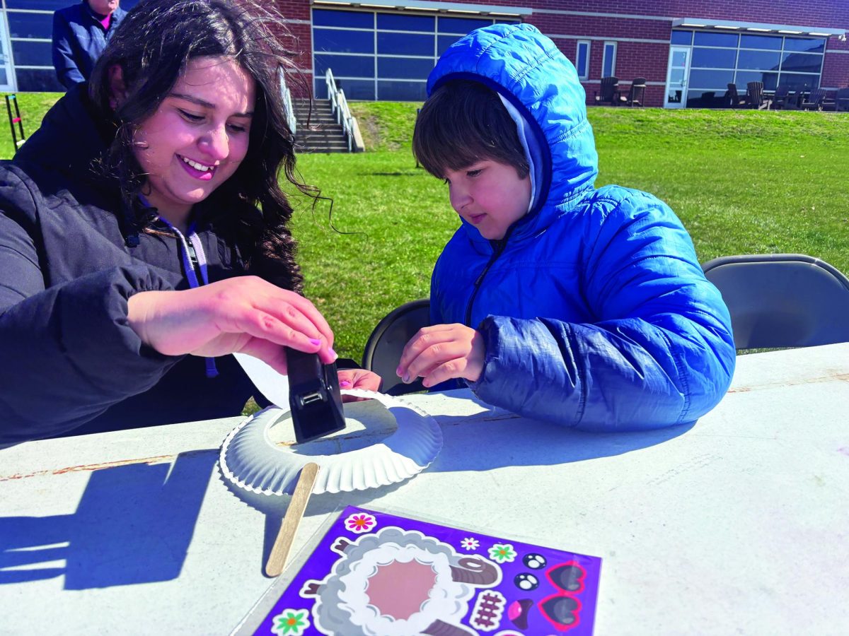 Hopping into spring…Making a paper plate bunny with the help of  Leo Club member Lyla Irizarry, Salford Hills third grader Lucas Hartman enjoys his time at the Leo Club Egg Hunt. Approximately 45 students attended the March 28 event. 
