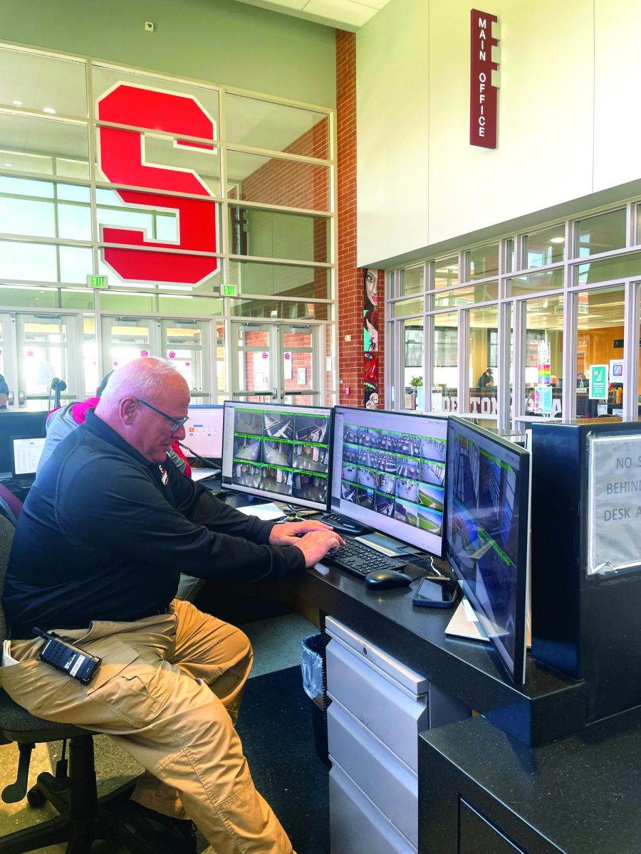Working it…Sitting at the Lower Road main entrance security desk on April 9, security guard Vince Manzo looks through security camera footage.