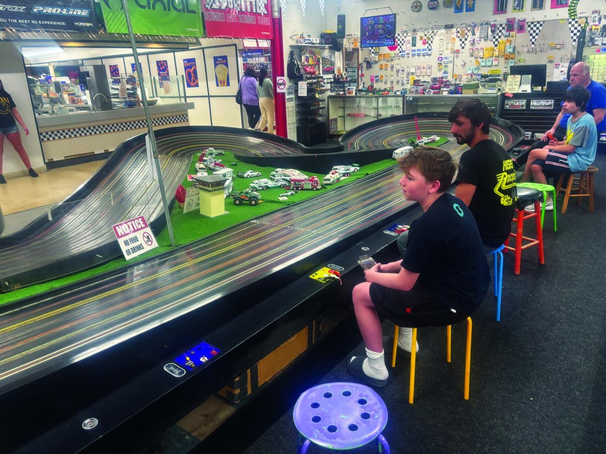 Ready, Set, Go…Enjoying a day at the Quakertown Farmers Market on April 4, sophomore Jackson Koenig races slot cars against Hess’ Raceplace co-owner Damien Donofrio. The slot cars are one of many experiences offered at the Q-Mart, located on Station Road in Quakertown.