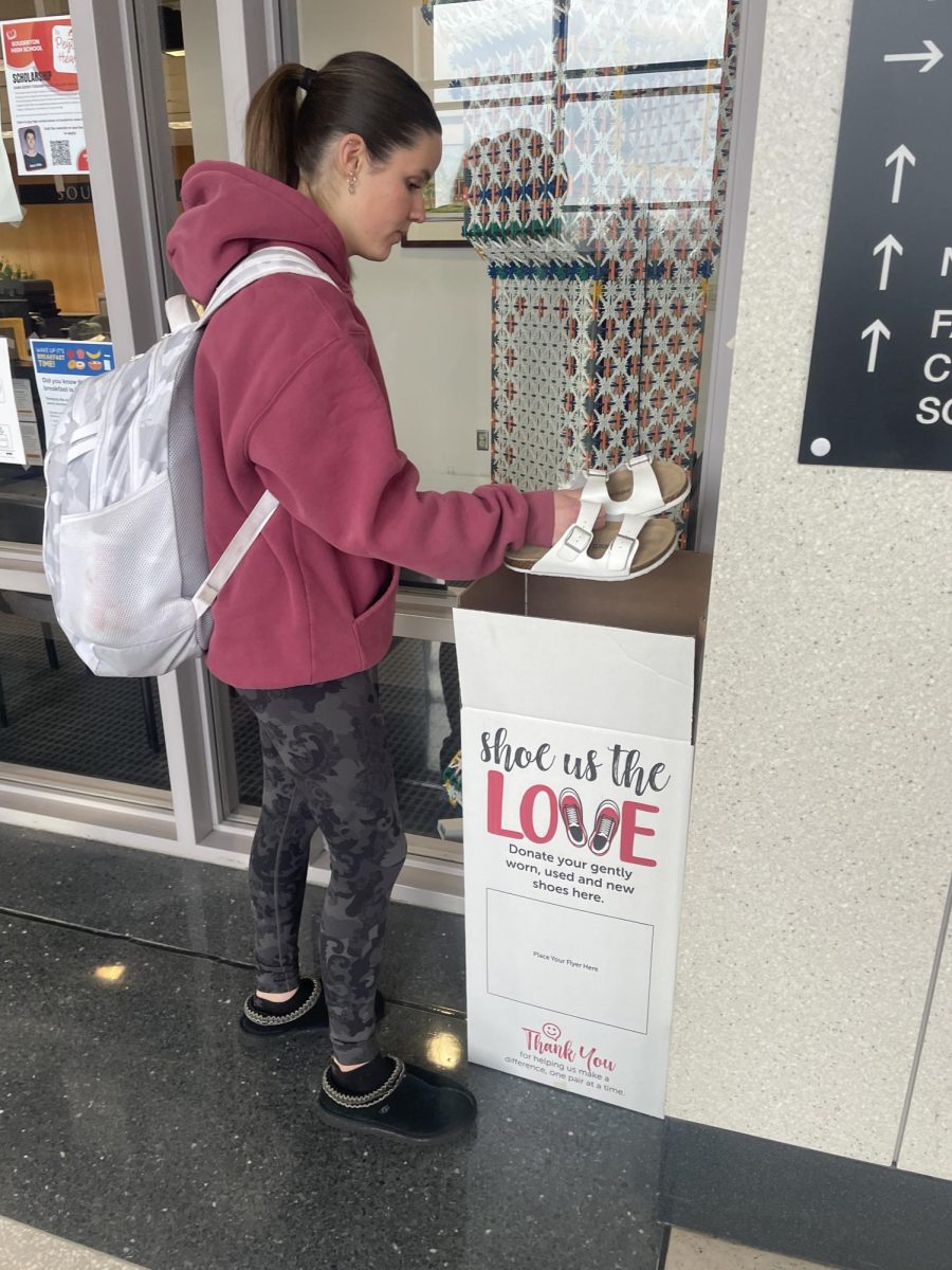  Giving back… Supporting FBLA, junior Abigail McDonald donates shoes to the donation bin. This fundraiser took place throughout February and March. 