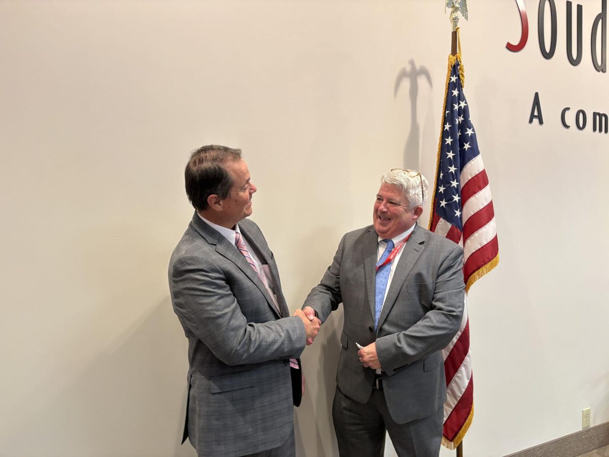 Passing the torch...After his promotion to superintendent at the April 30 school board meeting, Assistant Superintendent Christopher Hey (left) shakes hands with Superintendent Frank Gallagher. Gallagher is retiring on June 30 after 13 years in the position. Hey’s tenure as superintendent begins July 1. 