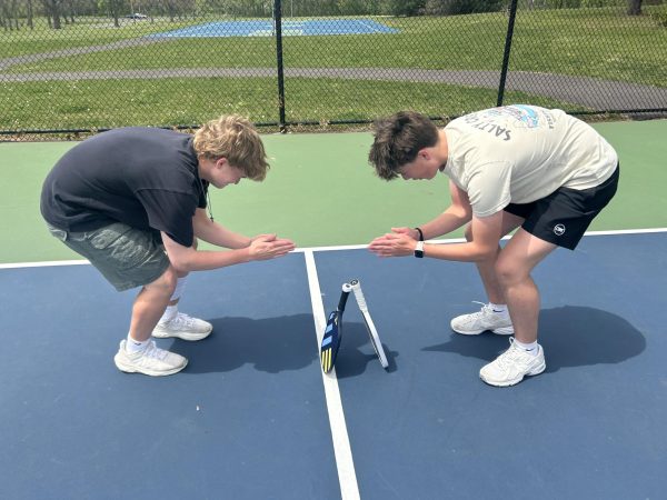 Boy Scouts 101...Warming up their hands after a winning a point, juniors Matthew Asman (left) and Nolan Nyce, celebrate together. During a pickleball match on May 2, Asman and Nyce pulled away with a 11-9 win against juniors Chase Snyder and Jack Newberry at Branchwood Park in Telford.